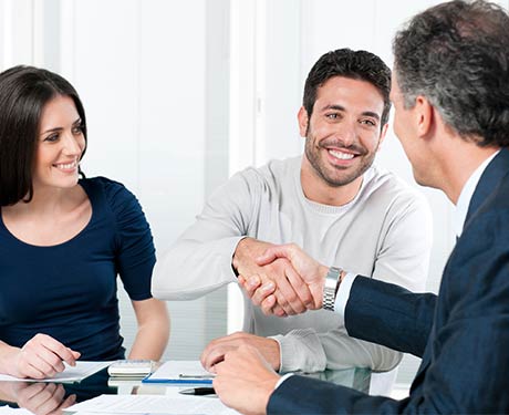 Happy Couple Reaching an Agreement with Businessman